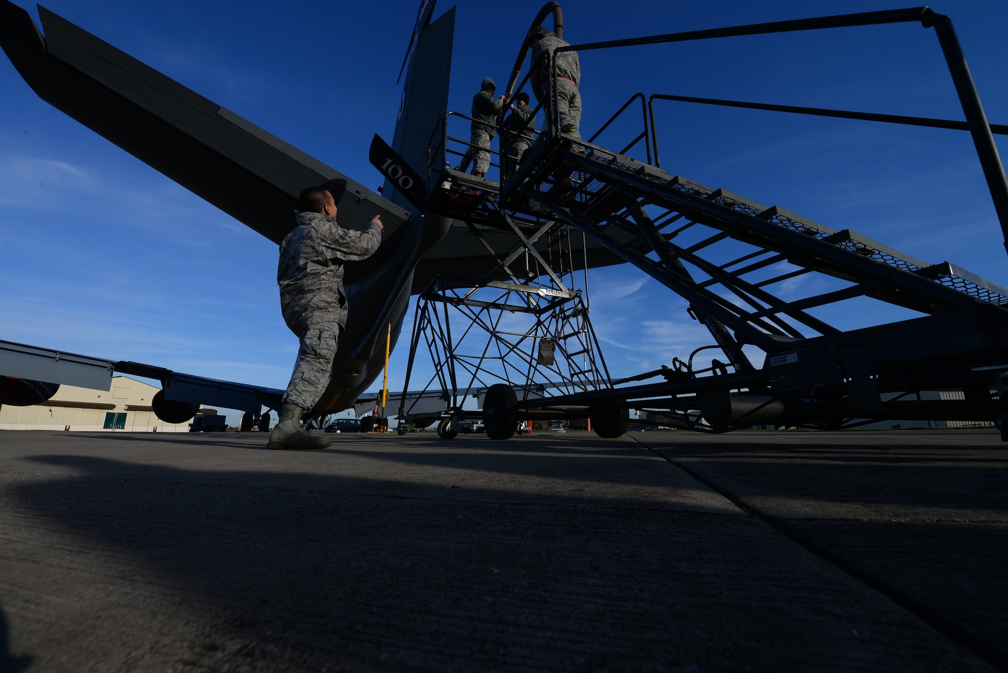 U.S. Air Force Staff Sgt. Karl Asuncion, 100th Maintenance Group jets quality assurance inspector, observes Airmen while they work on a KC-135 Stratotanker Jan. 13, 2016, on RAF Mildenhall, England. Information collected from inspections along with changing Air Force instructions and technical orders can be used by quality assurance Airmen to improve processes and procedures. (U.S. Air Force photo by Staff Sgt. Micaiah Anthony/Released)
