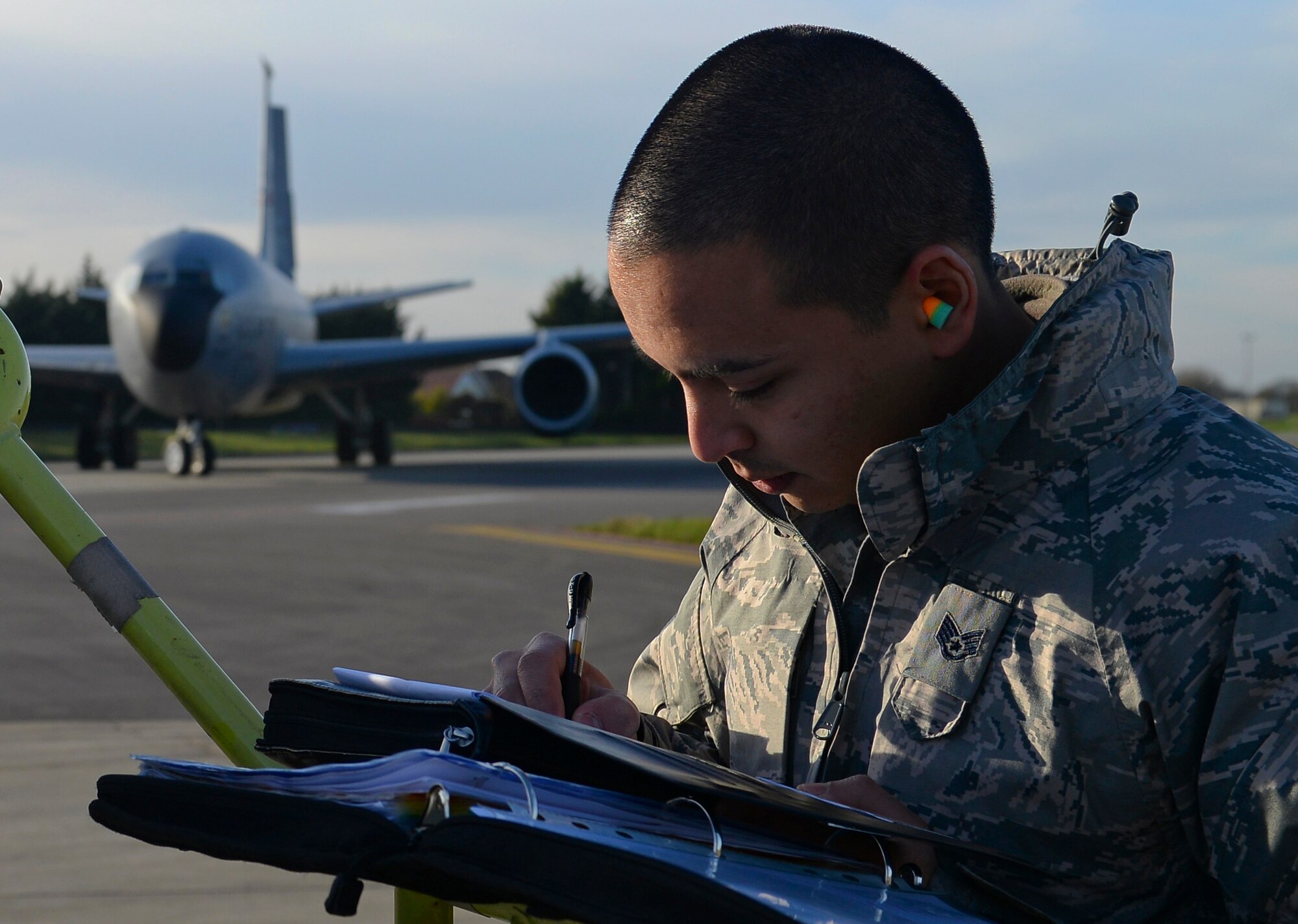 U.S. Air Force Staff Sgt. Karl Asuncion, 100th Maintenance Group jets quality assurance inspector, annotates information during an inspection Jan. 13, 2016, on RAF Mildenhall, England. Throughout the day, inspectors conduct three types of inspections; personnel evaluations, quality verification inspections and special inspections. (U.S. Air Force photo by Staff Sgt. Micaiah Anthony/Released)