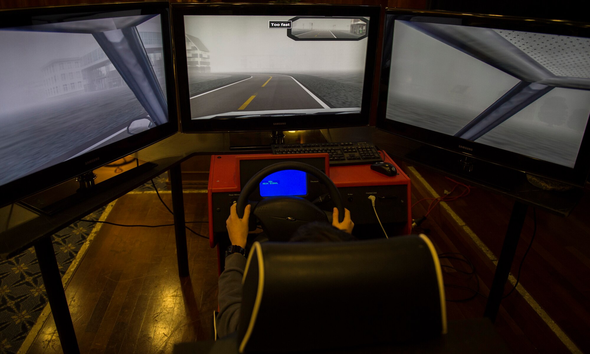 A Spangdahlem community member tests the safety driving simulator at the Health Celebration in the Club Eifel Ballroom on Spangdahlem Air Base, Germany, Jan. 21, 2016. The simulator can alter driving conditions such as weather, terrain and time of day and mimics the difficulties of driving while intoxicated. (U.S. Air Force photo by Airman 1st Class Luke Kitterman/Released)
