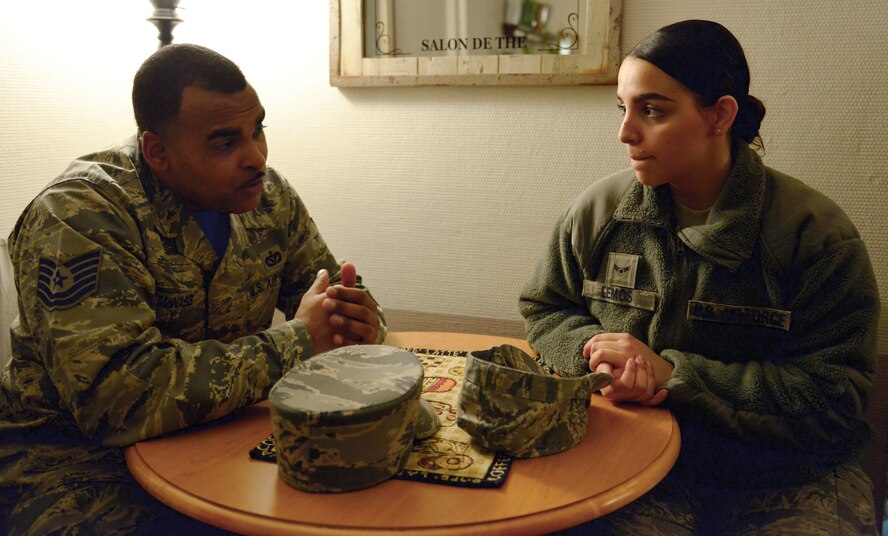 Tech. Sgt. Osealoa McNabb, Kisling NCO Academy instructor, speaks with Airman 1st Class Destiny Lemos, 86th Communications Squadron postal specialist, during a mentor-pairing event Jan. 15, 2015, at Ramstein Air Base, Germany. The KMC Mentorship Program held the event in an effort to provide Airmen the opportunity to learn from various leaders and promote personal and professional growth. Mentees are paired with mentors for a minimum four-month period. (U.S. Air Force photo/Staff Sgt. Sharida Jackson)