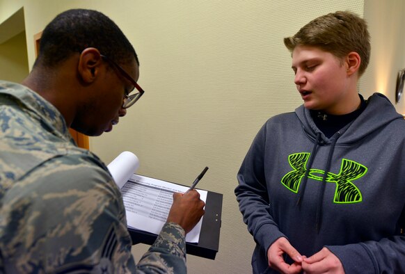 Senior Airman Richard Hellen, 569th U.S. Forces Police patrolman and Kaiserslautern Military Community Mentorship Program coordinator, checks in Airman 1st Class Heather Parks, 86th Communications Squadron information assurance technician, during a mentor pairing event Jan. 15, 2016, at Ramstein Air Base, Germany. Mentors and mentees were paired together for a minimum four-month period. (U.S. Air Force photo/Staff Sgt. Sharida Jackson)
