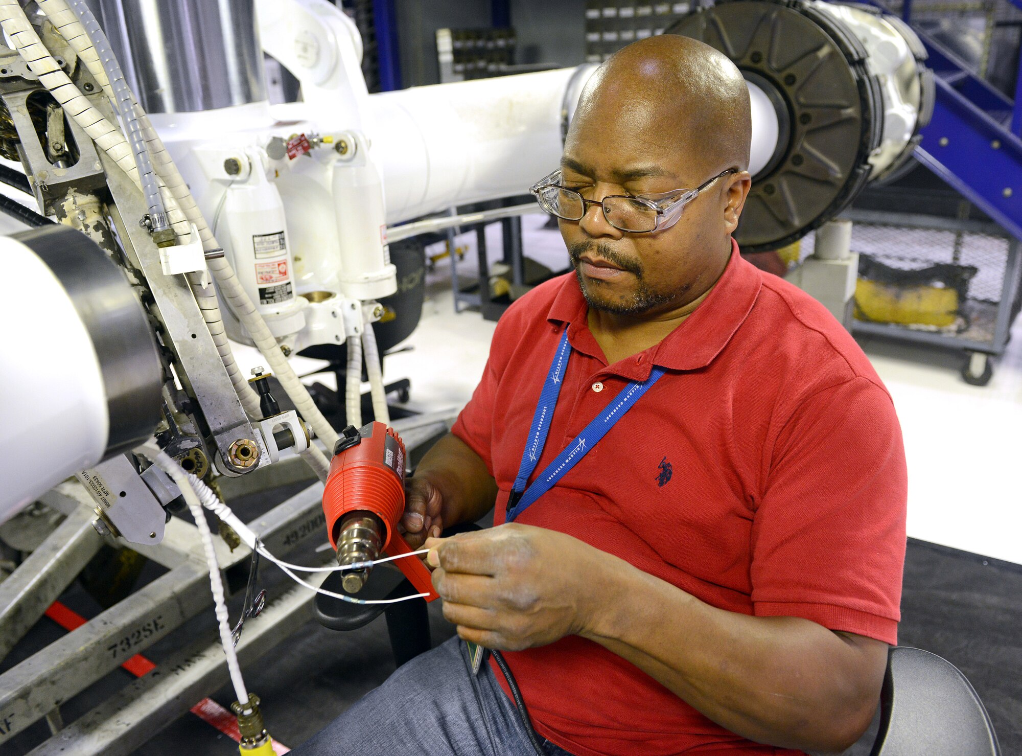 Alonzo Ellis, 559th Aircraft Maintenance Group aircraft electrician, installs a wiring harness on C-5 landing gear in a very clean and well lit work area in Dock 2. The landing gear shop 
 was first to set up in the newly refurbished facility. (U.S. Air Force photo by Tommie Horton)