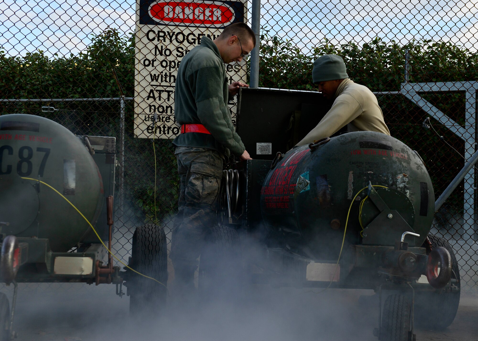 U.S. Air Force Airman Jesse Foley and Airman 1st Class Isiah Smothers, 31st Maintenance Squadron Electrical and Environmental journeymen, release pressure from a liquid oxygen tank, Jan. 20, 2016, at Aviano Air Base, Italy. The E&E section collaborates with the 31st Logistics Readiness Squadron Petroleum, Oils and Lubricants section to ensure each tank is ready for use on the flightline. (U.S. Air Force photo by Airman 1st Class Cary Smith/Released)