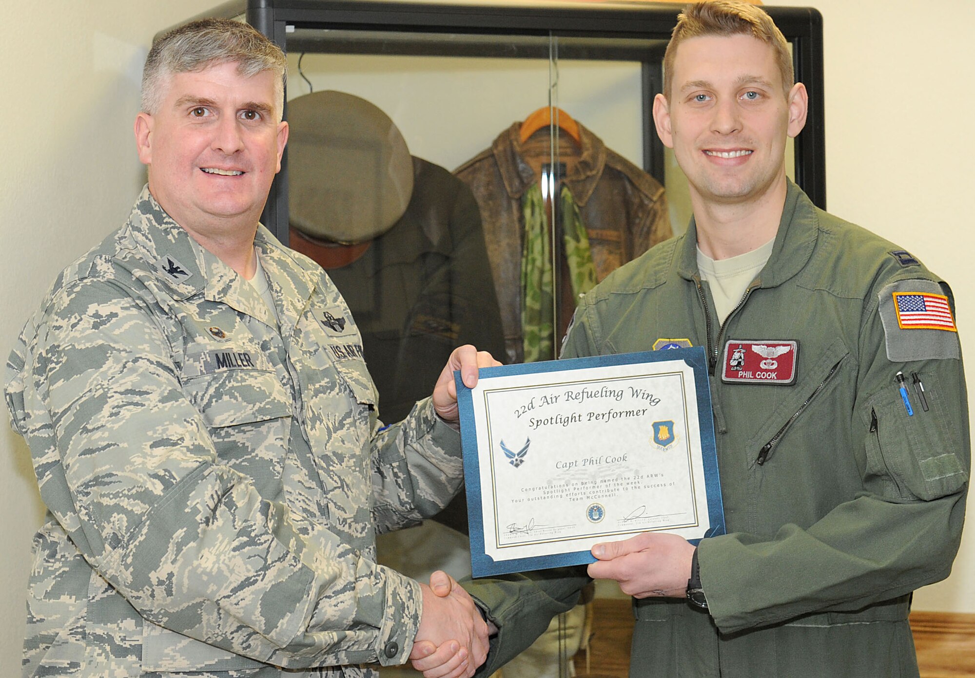 Capt. Phil Cook, 384th Air Refueling Squadron pilot and chief of safety, poses with Col. Albert Miller, 22nd Air Refueling Wing commander, Jan. 20, 2016, at McConnell Air Force Base, Kan. Cook received the spotlight performer for the week of Jan. 11 - 15 for his exceptional skills and maintain. (U.S. Air Force photo/Senior Airman David Bernal Del Agua)