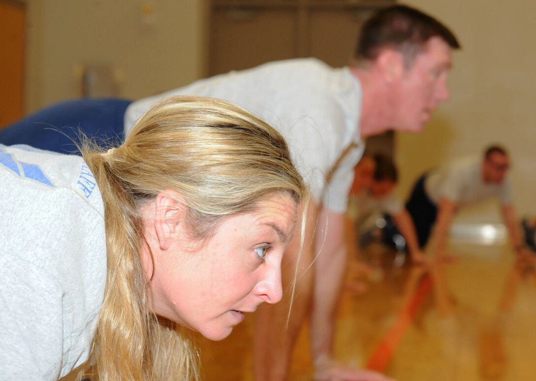Master Sgt. Rachael Hall, 22nd Force Support Squadron Airman Leadership School commandant, completes memorial push-ups after a volleyball game, Jan. 19, 2016, at McConnell Air Force Base, Kan. After every physical training session, ALS students and instructors perform push-ups to remember Airmen that have died in the line of duty. (U.S. Air Force photo/Senior Airman David Bernal Del Agua)