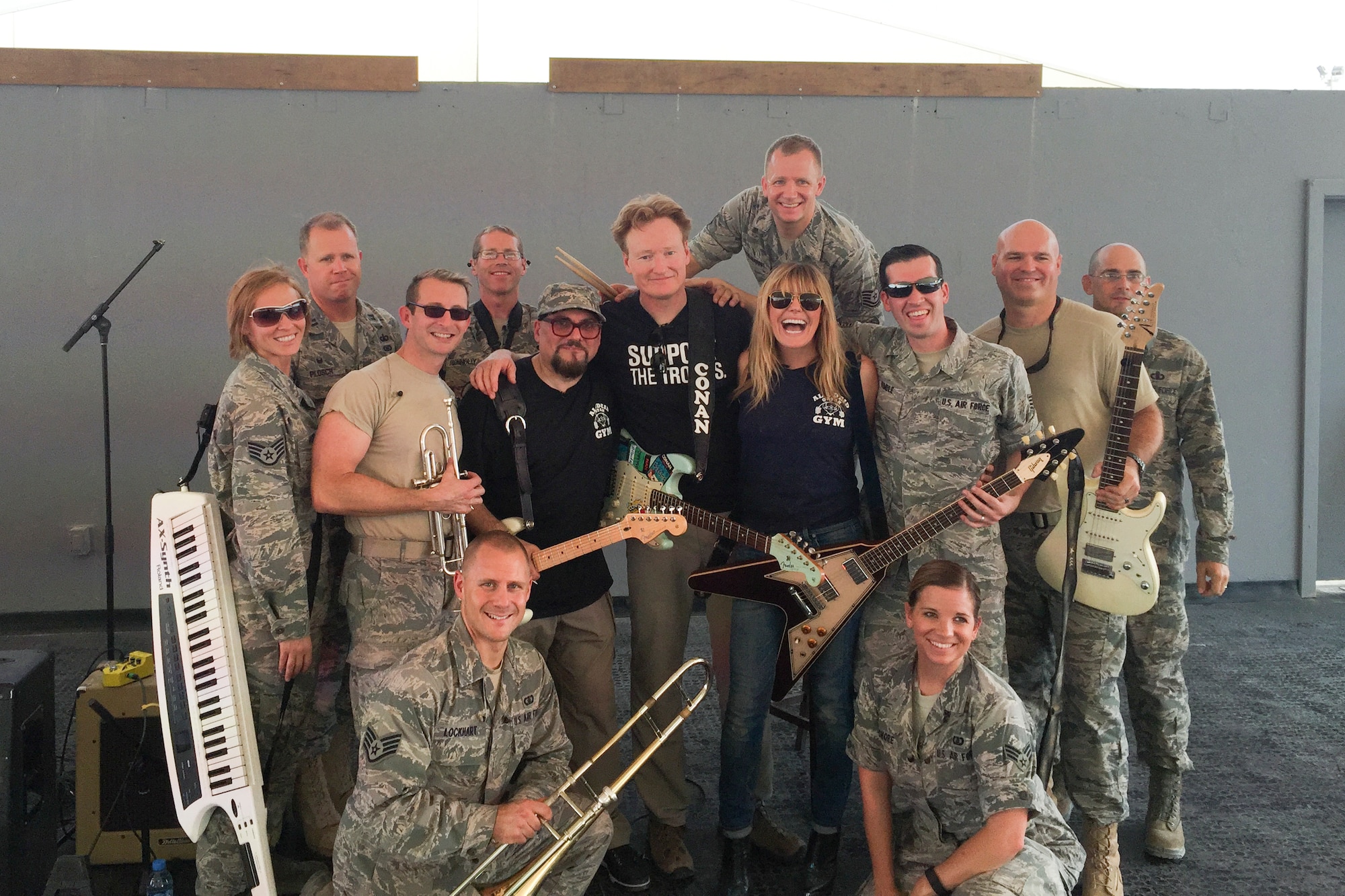 Members of the U.S. Air Force Heritage of America Band’s high-energy ensemble, Full Spectrum, pose for a photo with comedian Conan O’Brien, center left, and singer Grace Potter, center right, during their deployment tour with first lady Michelle Obama. The band was deployed for roughly 110 days, and toured various locations in the Middle East and Southwest Asia. (Courtesy photo/Released)