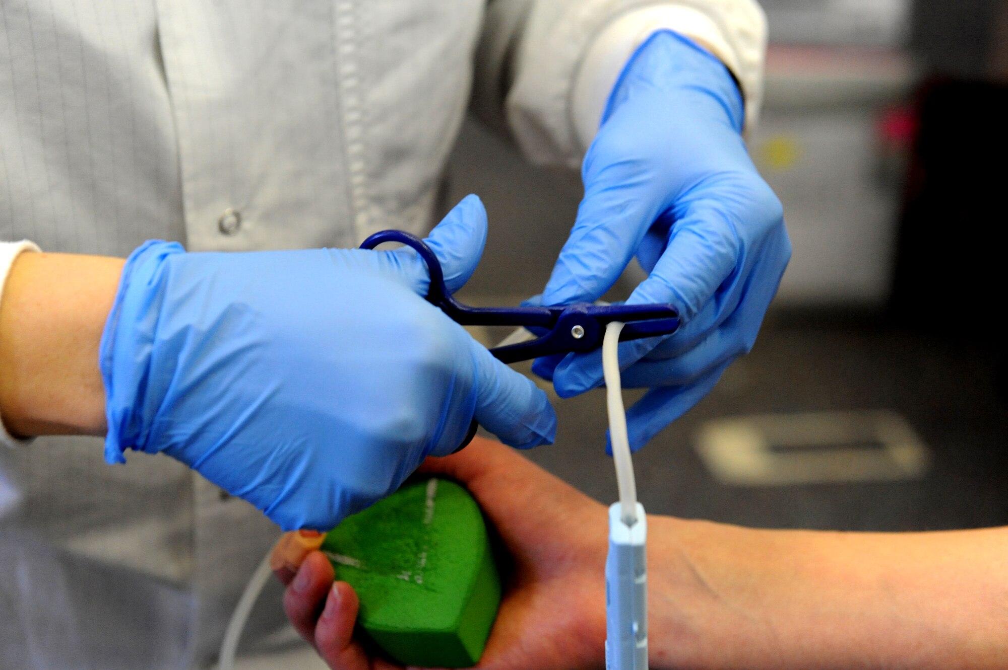 A collection specialist with the American Red Cross uses a specialty tool to seal a blood bag tube during a blood drive at Whiteman Air Force Base, Mo., Jan. 13, 2016. After the blood is collected each donation is scanned into a computer database, tested for infectious diseases, stored in a refrigerator at 6 degrees Celsius for up to 42 days and distributed to one of 2,600 hospitals across the U.S . (U.S. Air Force photo by Tech. Sgt. Miguel Lara III)