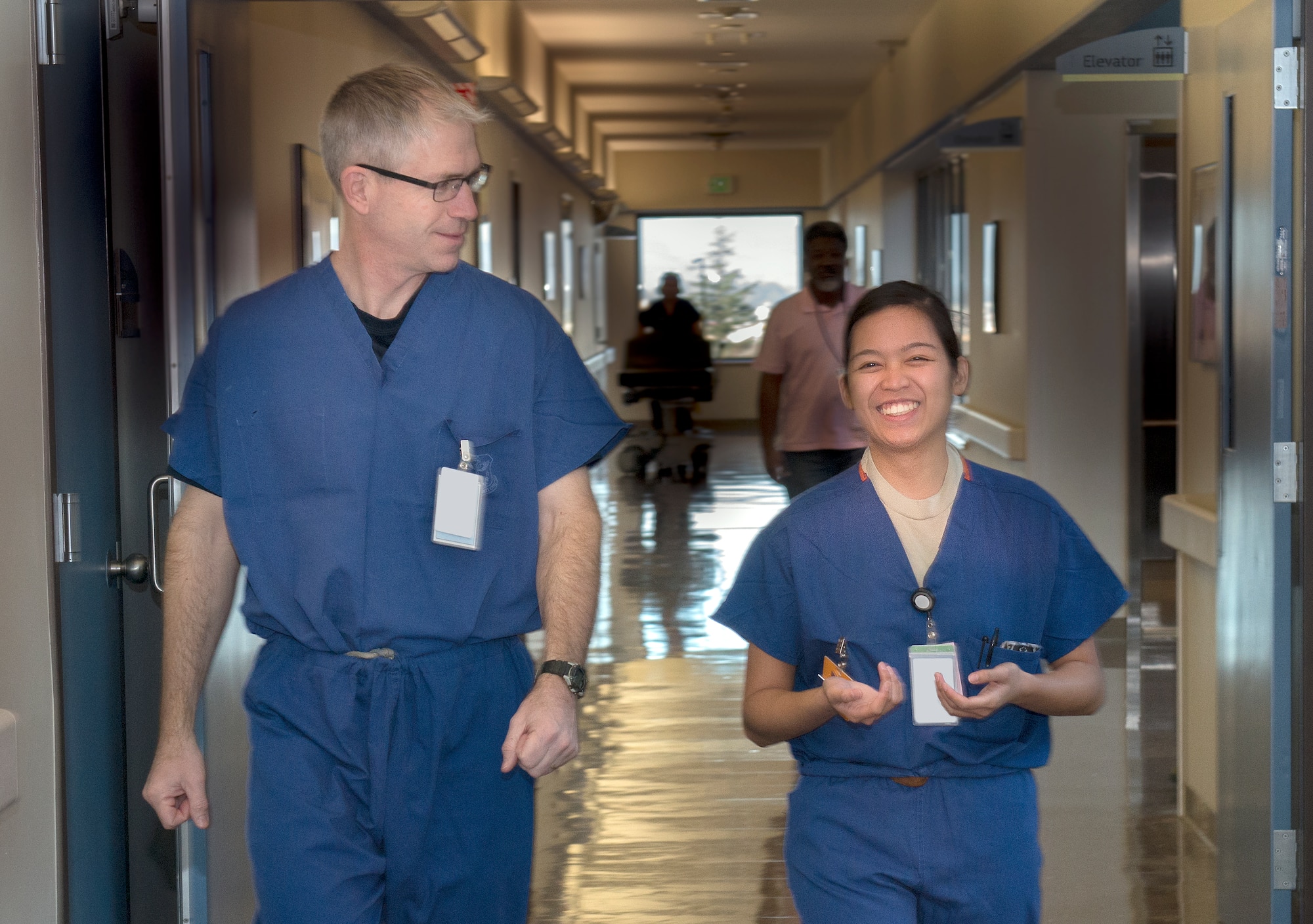 Airman 1st Class Athena Layman, right, 60th Surgical Operations Squadron surgical technician, walks with Col. Joel Jackson, 60th Air Mobility Wing commander, Jan. 15, 2016, prior to Jackson shadowing her for the day as part of the Works With Airman program at Travis Air Force Base, California, The purpose of the program is to allow senior base leadership to shadow a junior Airman within their primary duties. (U.S. Air Force photo by Heide Couch)