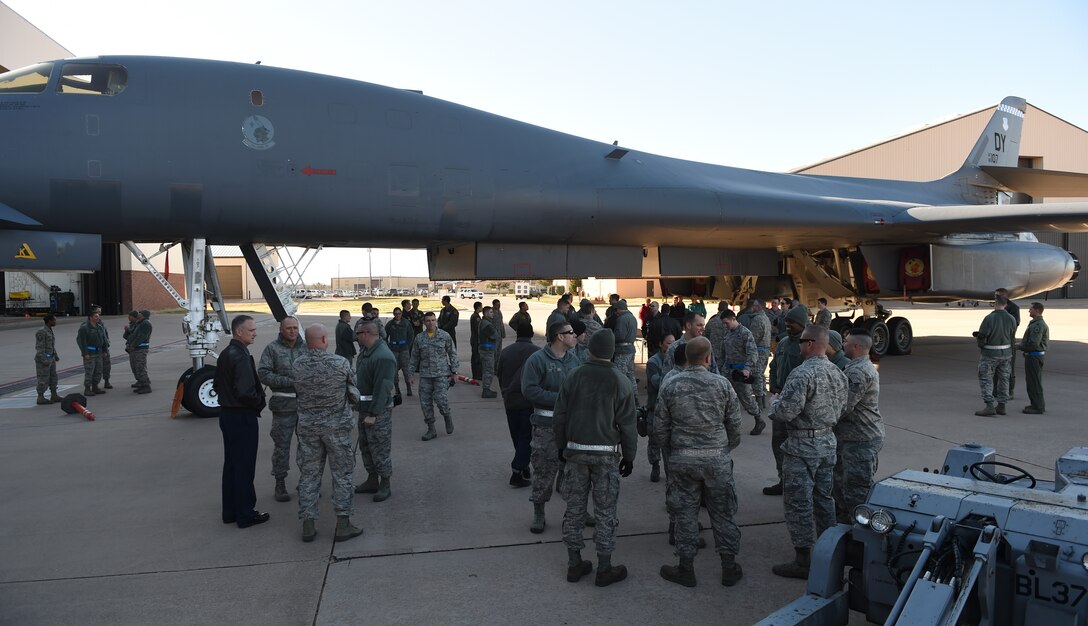 U.S. Air Force Airmen gather to offer congratulations to the competing teams in the Annual Load Crew Competition Jan. 15, 2016, at Dyess Air Force Base, Texas. Load crews from the 9th and 28th AMU competed against each other to see who could first load all of their training munitions with the 9th AMU declared the winners. The Annual Load Crew Competition builds esprit de corps and encourages professional development within the Dyess AFB AMU. (U.S. Air Force photo by Senior Airman Alexander Guerrero/Released)