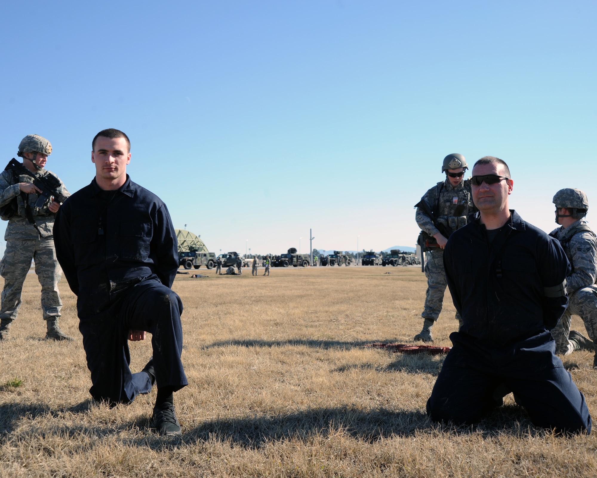 U.S. Airmen from the 39th Security forces defenders guard detained opposing forces during an exercise Jan. 15, 2016, on Incirlik Air Base, Turkey. As part of the exercise defenders practiced body searching techniques on the simulated opposing forces. (U.S. Air Force photo by Airman 1st Class Daniel Lile/Released)