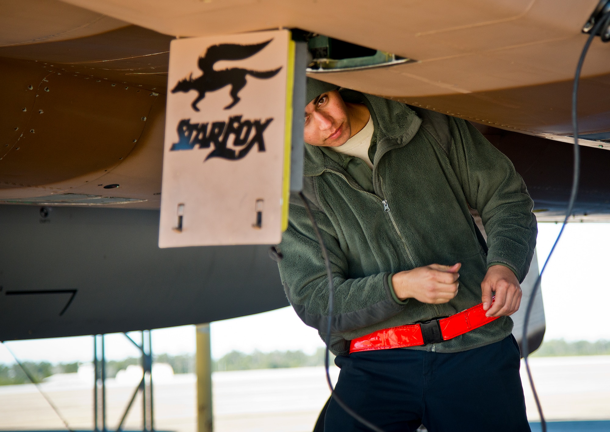 Senior Airman Oscar Mares, 96th Aircraft Maintenance Squadron, performs preflight checks on an F-15 Eagle prior to a sortie Jan. 20 at Eglin Air Force Base, Fla.  The camouflage aircraft is the only one painted this way on the base. Its Jan. 20 sortie marked the last time it would fly with that paint scheme before being returned to the traditional gray.  The F-15 was painted that way for its role as an aggressor aircraft in combat flight training exercises at Nellis Air Force Base, Nev.  (U.S. Air Force photo/Samuel King Jr.)
