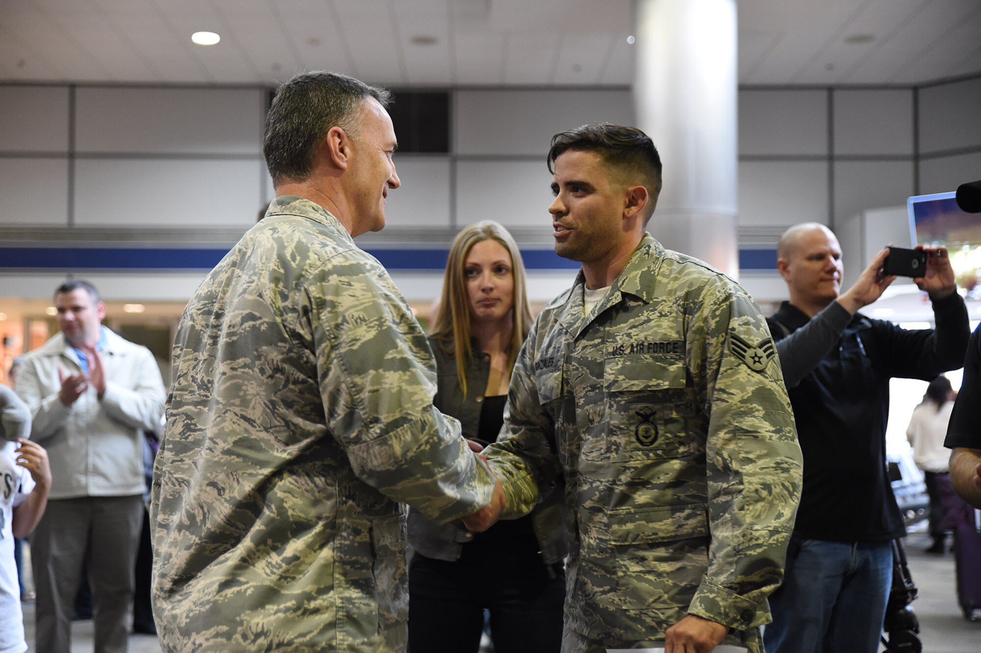 U.S. Air Force Senior Airman Christopher Gonzales, 144th Security Forces Squadron, is welcomed home and promoted to Staff Sgt. by Lt. Col. Dave Johnston, 144th Security Forces Squadron commander, at the Fresno Yosemite International Airport Jan. 21, 2015. Senior Airman Gonzales was deployed for more than seven months in support of Operation Enduring Freedom. (U.S. Air National Guard photo by Senior Master Sgt. Chris Drudge)