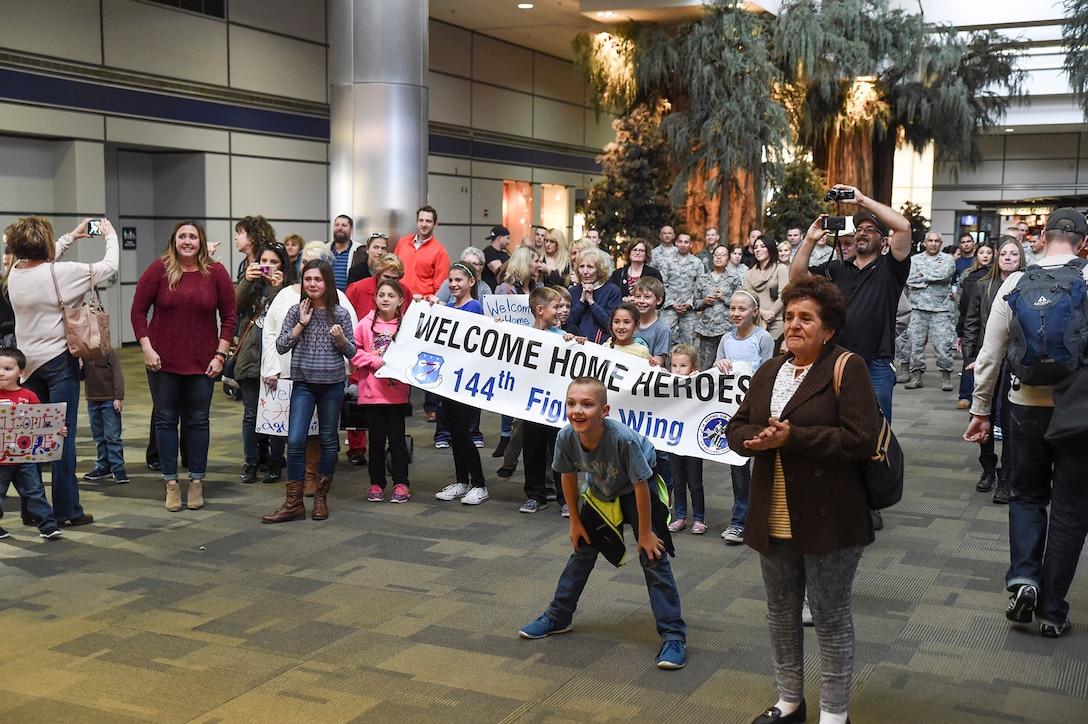 Family and friends of the 144th Security Forces Squadron prepare to greet Airmen who are returning from a deployment of more than seven months in support of Operation Enduring Freedom. The first group returned Jan. 21, 2015 at the Fresno Yosemite International Airport. (U.S. Air National Guard photo by Senior Master Sgt. Chris Drudge)