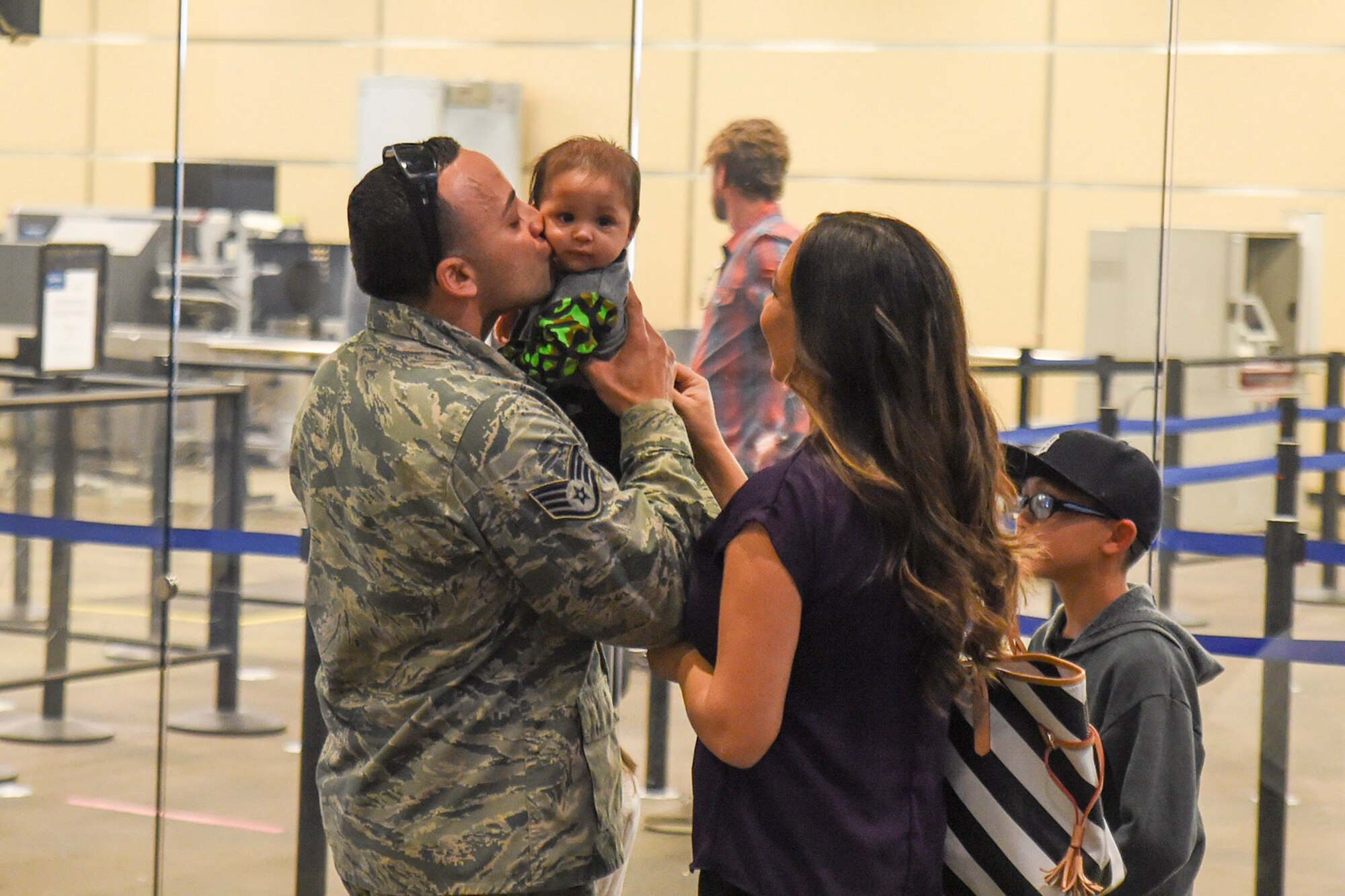 U.S. Air Force Staff Sgt. Roberto Sanchez, 144th Security Forces Squadron, meets his son for the first time upon his return from deployment in support of Operation Enduring Freedom. Staff Sgt. Sanchez and several other Airmen were deployed for more than seven months and were greeted by friends and family at the Fresno Yosemite International Airport Jan. 21, 2015. (U.S. Air National Guard photo by Senior Master Sgt. Chris Drudge)