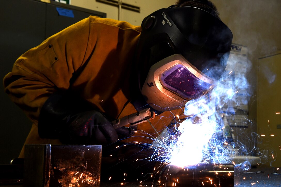 Airman 1st Class Tyler Steenbeke-Notaro welds brackets together to mount on the base perimeter wall on Altus Air Force Base, Okla., Jan. 15, 2016. Steenbeke-Notaro is a structural apprentice with the 97th Civil Engineer Squadron. U.S. Air Force photo by Airman 1st Class Megan Myhre