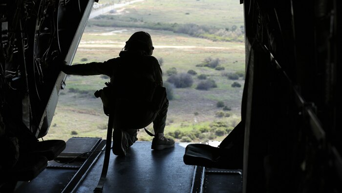 Cpl. Joshua Payne, a crew chief with Marine Medium Tiltrotor Squadron (VMM) 161 and a Spring, Texas, native, guides the pilots of an MV-22B Osprey to an unprepared field during casualty-evacuation training aboard Marine Corps Base Camp Pendleton, Calif., Jan. 20. Casualty-evacuation training prepares the Marines to land in a combat zone, pick up injured Marines and transport them to a safe area. 