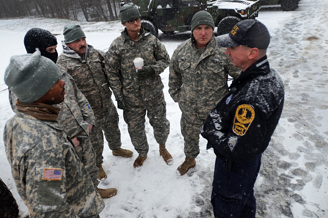 A Virginia state policeman briefs soldiers for winter weather response operations in Fairfax, Va., Jan. 22, 2016. The soldiers are assigned to the Virginia Army National Guard’s 116th Brigade Special Troops Battalion, 116th Infantry Brigade Combat Team. The Virginia National Guard has approximately 400 members staged at readiness centers along the Interstate 81 corridor between Lexington and Winchester; the Route 29 corridor from Warrenton to Danville; and around Richmond, Fredericksburg and Gate City. U.S. Army photo by Master Sgt. A.J. Coyne