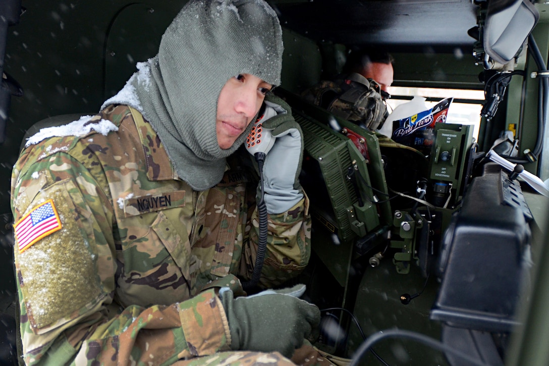 Army Spc. Nguyen communicates with fellow guardsmen in Humvees as they follow a Virginia State Police vehicle for possible winter weather response operations in Fairfax, Va., Jan. 22, 2016. Nguyen is assigned to the Virginia Army National Guard’s 116th Brigade Special Troops Battalion, 116th Infantry Brigade Combat Team. U.S. Army photo by Master Sgt. A.J. Coyne