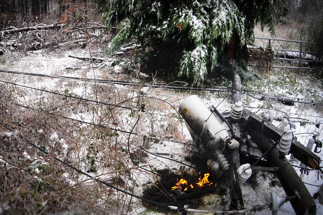 An electrical transformer and cables burn after falling due to heavy snow and ice in Greenville and Travelers Rest, S.C., Jan. 22, 2016. South Carolina National Guard photo by Army Staff Sgt. Roby Di Giovine