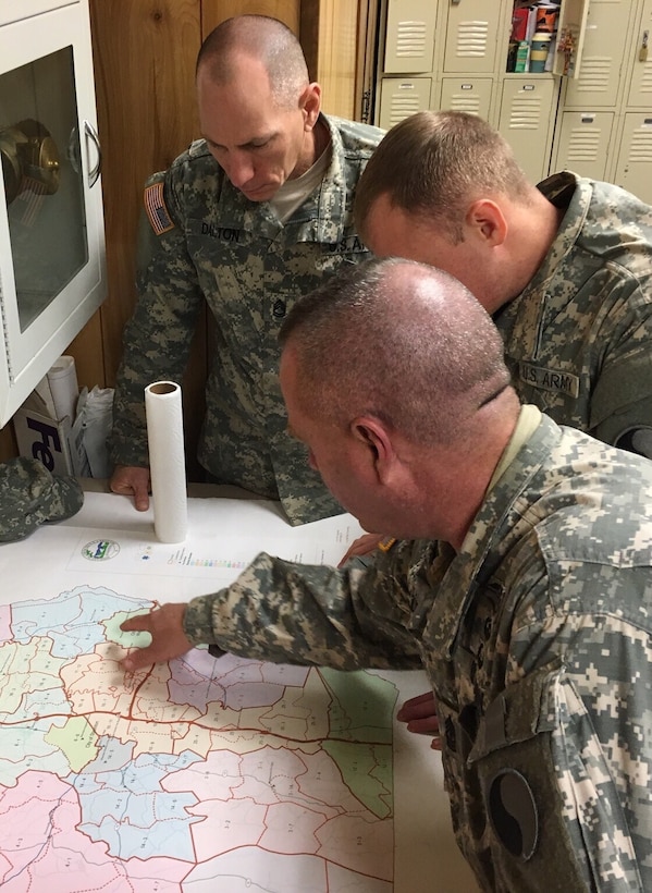 Army 1st Sgt. Phillips, foreground, briefs Sgt. 1st Class Dalton and another soldier before they move out for a patrol during a winter storm in Verona, Va., Jan. 22, 2016. Phillips and Dalton are assigned to the Virginia Army National Guard’s Headquarters Company, 116th Infantry Brigade Combat Team. Virginia National Guard photo by Army Sgt. Chris Martrano