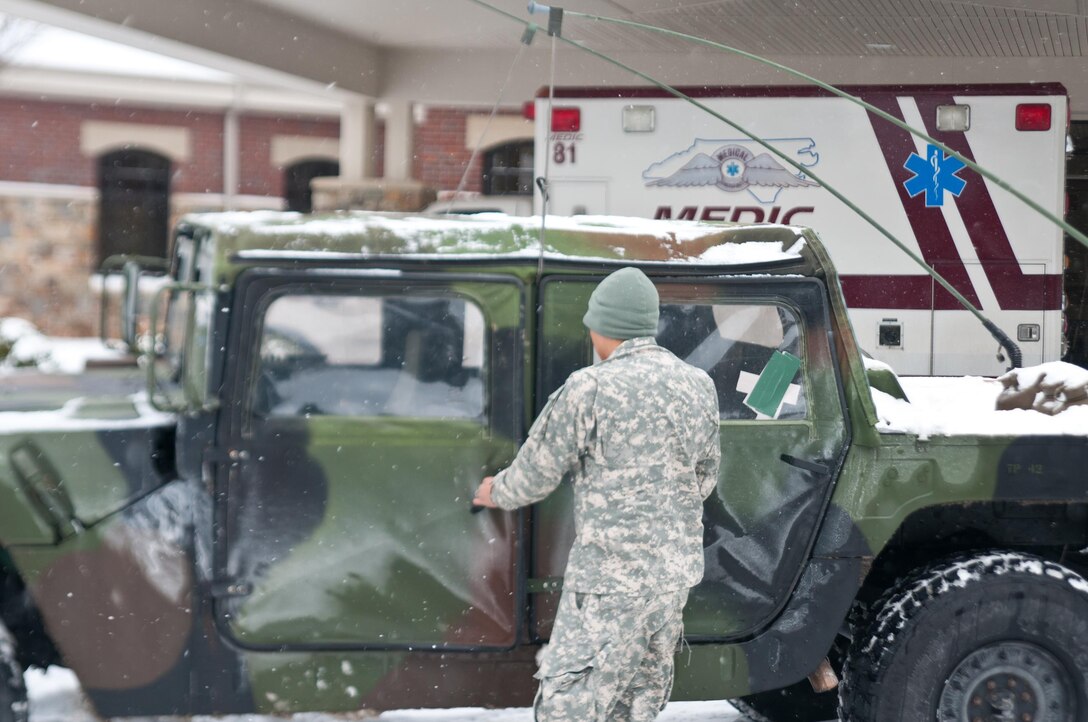Army Spc. Kevin Thomas parks his Humvee outside of a medical clinic after transporting a stranded resident to his dialysis treatment in Asheville, N.C., Jan. 23, 2016. Thomas is assigned to the North Carolina National Guard’s Headquarters Company, 105th Military Police Battalion. North Carolina National Guard photo Sgt. Brian Godette