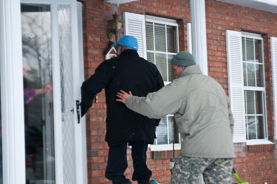 Army Sgt. Colin Kalescky, right, helps escort Charles Harbison, an 86-year-old resident of Asheville, N.C., as he returns home following his dialysis treatment at the Davita Kidney Care Center, Jan. 23, 2016. Kalescky is assigned to the North Carolina National Guard’s Headquarters Company, 105th Military Police Battalion. North Carolina National Guard photo Sgt. Brian Godette
