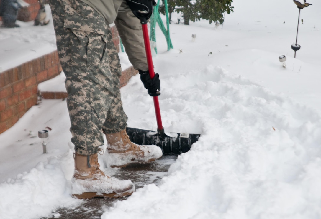Following the safe return of Charles Harbison, an 86 year-old dialysis patient who was transported by a North Carolina National Guard winter storm catch team, Army Sgt. Colin Kalescky shoveled Harbison's walk way at his home in Asheville, N.C., Jan. 23, 2016. Kalescky is assigned to the North Carolina National Guard’s Headquarters Company, 105th Military Police Battalion. North Carolina National Guard photo Sgt. Brian Godette