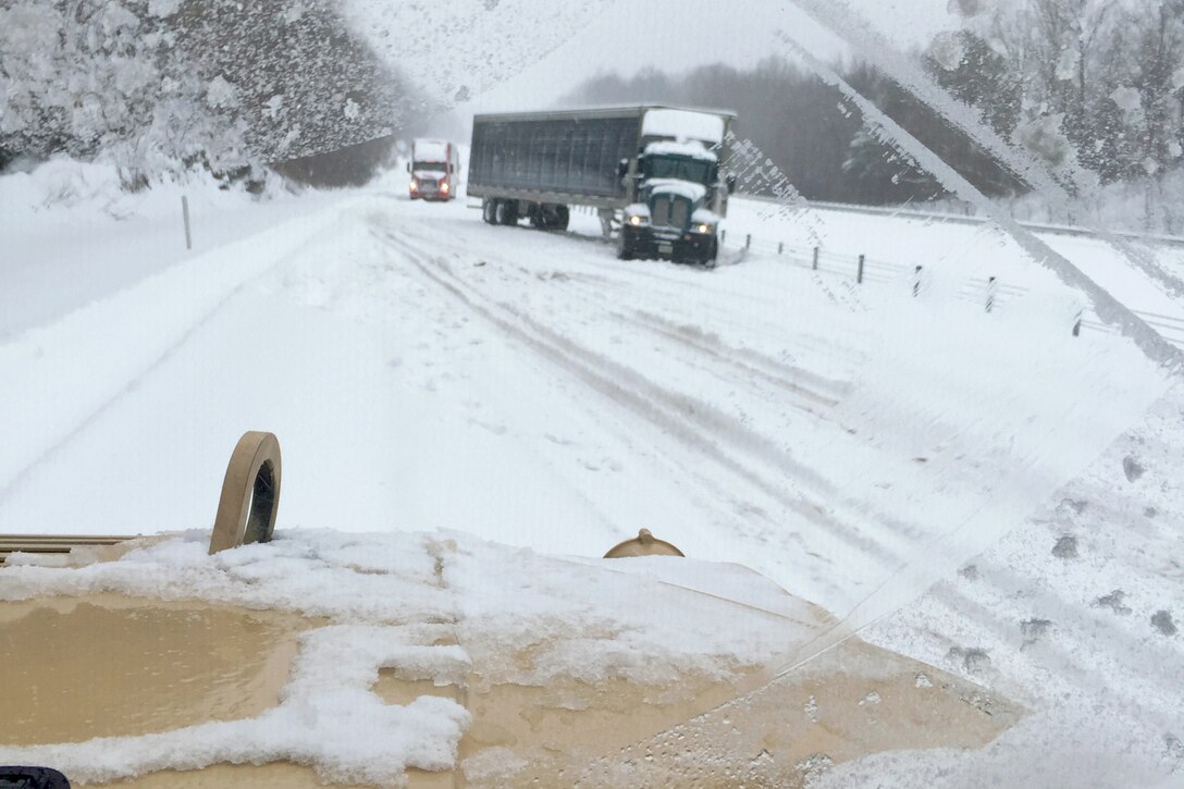 Soldiers assist motorists on Interstate 75 south of Lexington, Ky., Jan. 23, 2016, during winter storm response operations. The soldiers are assigned to the Kentucky National Guard’s 203rd Forward Support Company. The Kentucky National Guard mobilized more than 120 soldiers at multiple locations across the state to provide support during the storm. Kentucky National Guard photo