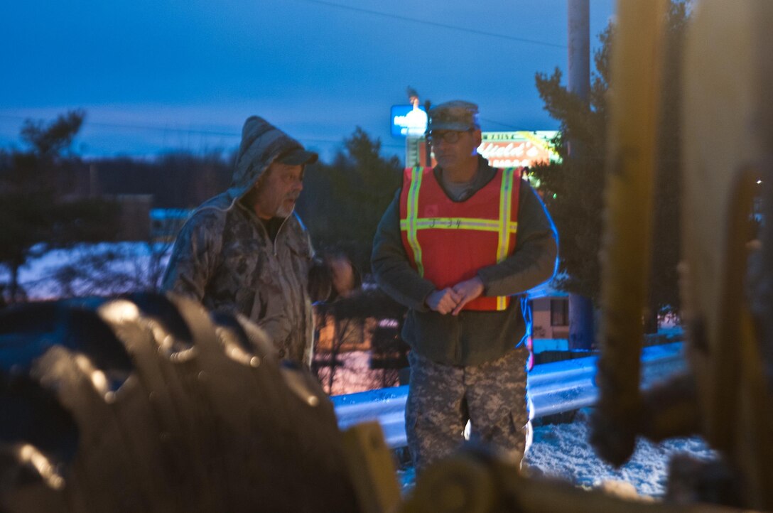 Army Staff Sgt. Brendan Stephens, right, provides a wellness check on a Department of Transportation employee after seeing his snow plow had broken down on the side of a road in Greensboro, N.C., Jan. 24, 2016. Stephens is assigned to the 382nd Public Affairs Detachment. North Carolina National Guard photo by Sgt. Brian Godette
