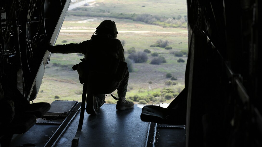 Cpl. Joshua Payne, a crew chief with Marine Medium Tiltrotor Squadron 161 and a Spring, Texas, native, guides the pilots of an MV-22B Osprey to an unprepared field during casualty-evacuation training aboard Marine Corps Base Camp Pendleton, Calif., Jan. 20, 2016. Casualty-evacuation training prepares the Marines to land in a combat zone, pick up injured Marines and transport them to a safe area. 