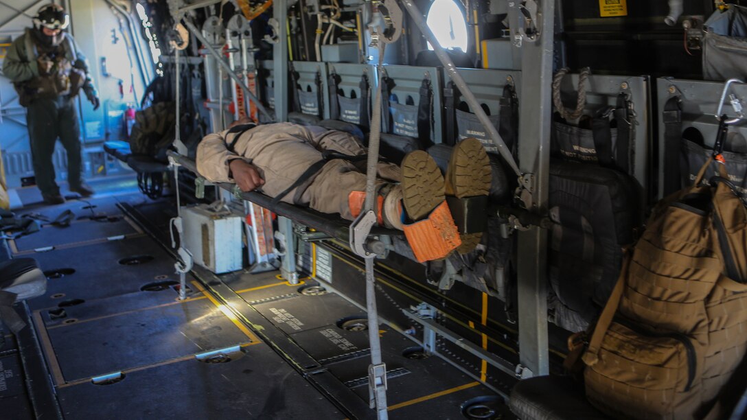 A Marine preparing to deploy with the 31st Marine Expeditionary Unit lies on a litter after being brought onto an MV-22B Osprey with Marine Medium Tiltrotor Squadron 161 during casualty-evacuation training aboard Marine Corps Base Camp Pendleton, Calif., Jan. 20. Casualty-evacuation training prepares the Marines to land in a combat zone, pick up injured Marines and transport them to a safe area. 