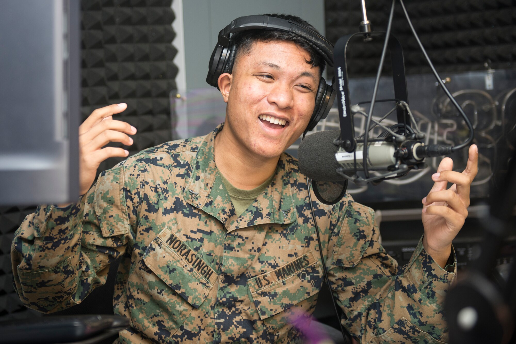 U.S. Marine Corps Lance Cpl. Takoune Norasingh, American Forces Network Okinawa broadcaster, hosts the AFN afternoon show Jan. 21, 2016, in Okinawa, Japan. AFN Okinawa provides local command information in the form of entertainment for more than 60,000 listeners. (U.S. Air Force photo by Senior Airman Omari Bernard)