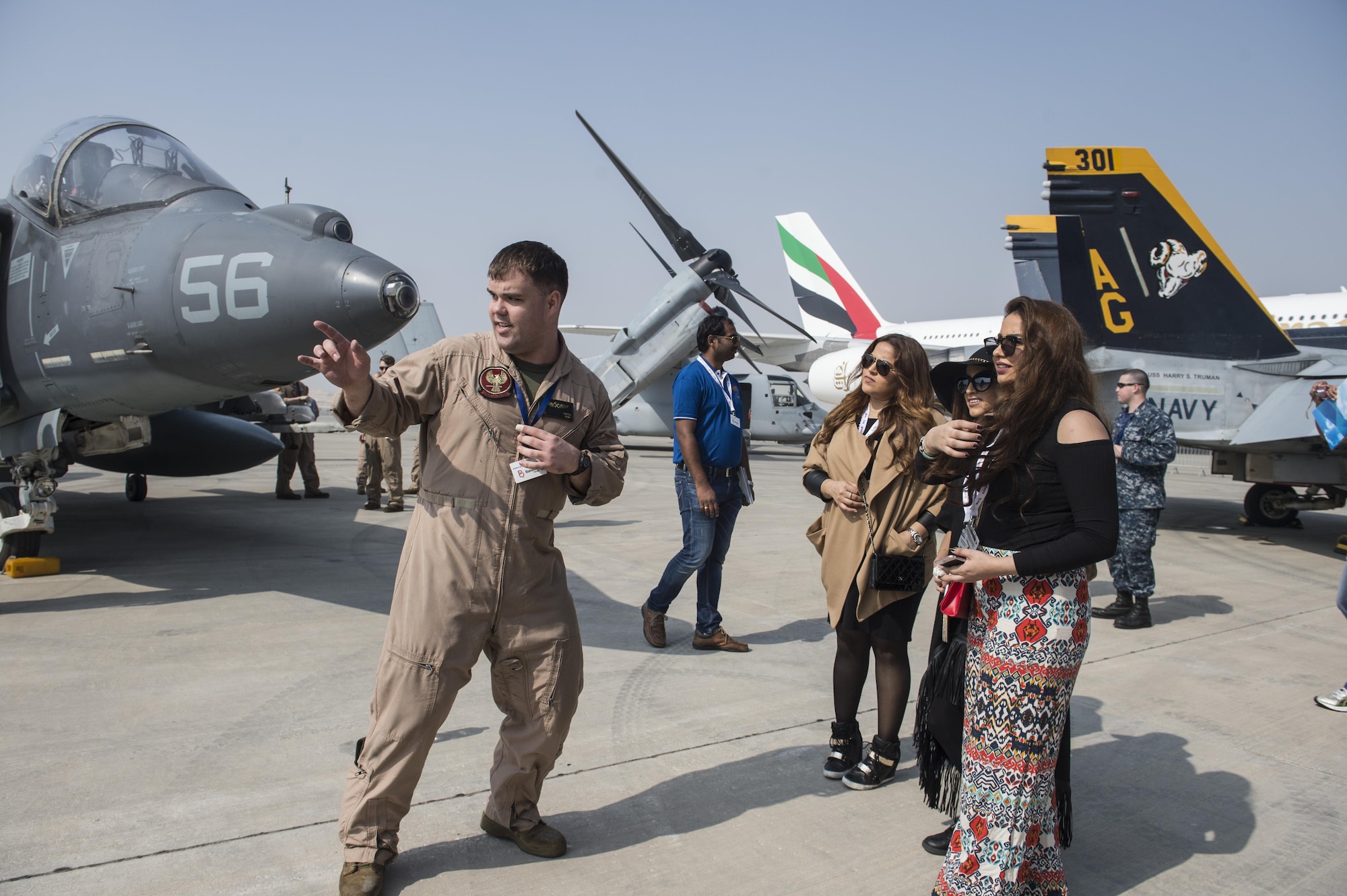 A United States Marine speaks with Bahrain locals about U.S. military aircraft during the Bahrain International Airshow at Sakhir Airbase in Manama, Bahrain, Jan. 21, 2016. The Bahrain International Airshow 2016 is a biennial, three-day aviation and aerospace industry event that provides the U.S. military an opportunity to highlight DOD aviation technology. (U.S. Air Force photo by Staff Sgt. Corey Hook/Released)