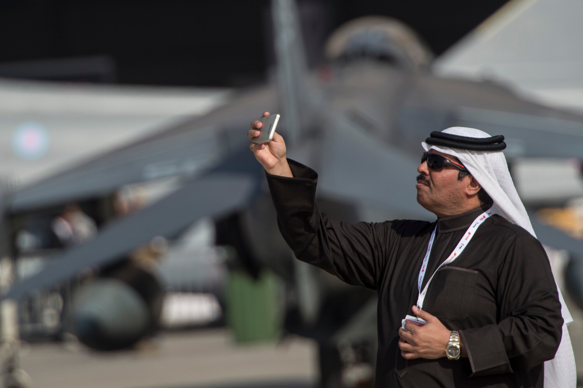 A Bahrain airshow guest takes a selfie at the Bahrain International Airshow at Sakhir Airbase in Manama, Bahrain, Jan. 21, 2016. The Bahrain International Airshow 2016 is a biennial, three-day aviation and aerospace industry event that provides the U.S. military an opportunity to highlight DOD aviation technology. (U.S. Air Force photo by Staff Sgt. Corey Hook/Released)