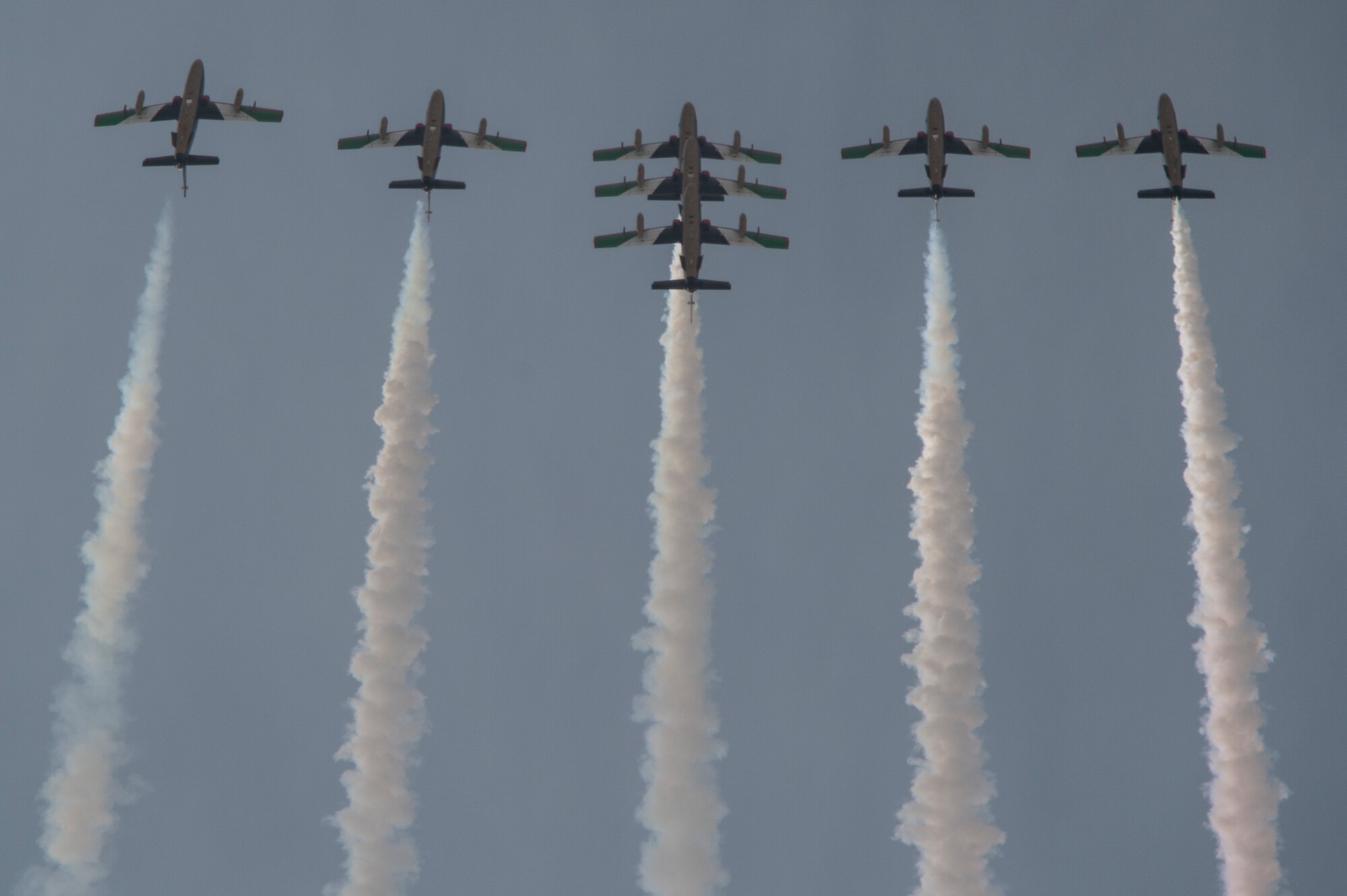 The United Arab Emirates Air Force Al Fursan demonstration team perform at the Bahrain International Airshow at Sakhir Airbase in Manama, Bahrain, Jan. 22, 2016. The Al Fursan planes are painted in black, gold, white, red and green colors and are equipped with smoke generators producing red, green, white and black smoke which are their national flag colors. (U.S. Air Force photo by Staff Sgt. Corey Hook/Released)