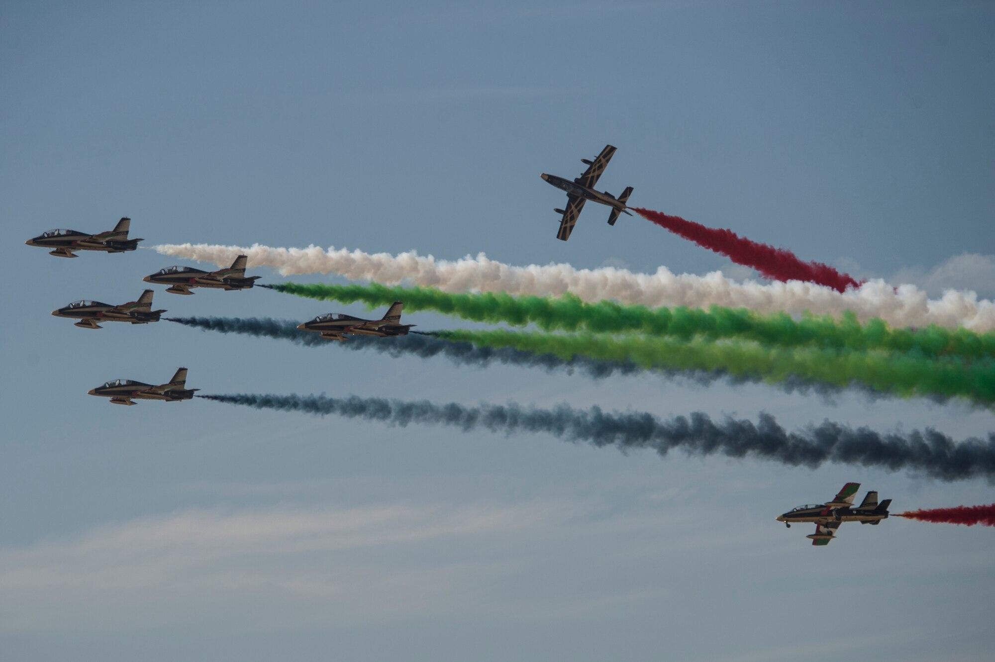 The United Arab Emirates Air Force Al Fursan demonstration team perform at the Bahrain International Airshow at Sakhir Airbase in Manama, Bahrain, Jan. 22, 2016. The Al Fursan planes are painted in black, gold, white, red and green colors and are equipped with smoke generators producing red, green, white and black smoke which are their national flag colors. (U.S. Air Force photo by Staff Sgt. Corey Hook/Released)