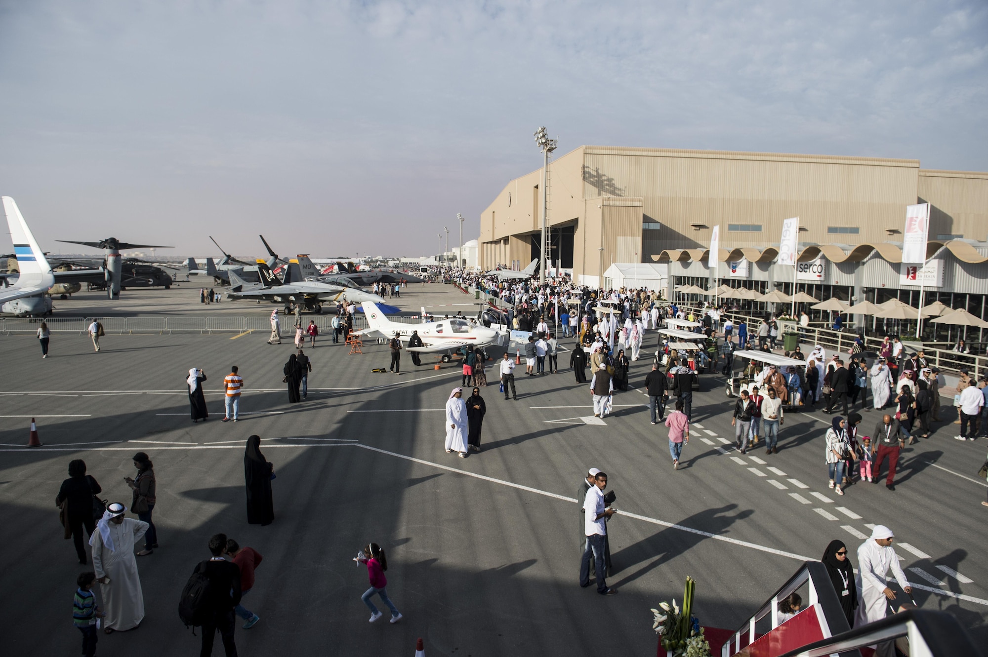 Spectators attend the Bahrain International Airshow at Sakhir Airbase in Manama, Bahrain, Jan. 23, 2016. The Bahrain International Airshow 2016 is a biennial, three-day aviation and aerospace industry event that provides the U.S. military an opportunity to highlight DoD aviation technology. (U.S. Air Force photo by Staff Sgt. Corey Hook/Released)