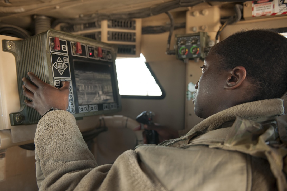 Air Force Senior Airman Amanda Nolan scans a sector on a common remote operating weapons station from a mine-resistant ambush protected vehicle at Delta-1 Post on Kandahar Airfield, Afghanistan, Jan. 20, 2016. Nolan is assigned to the 451st Expeditionary Support Squadron Security Forces Flight. The post provides flightline security and over watch for convoys returning from outside-the-wire missions in conjunction with security positions held by additional NATO forces. U.S. Air Force photo by Tech. Sgt. Robert Cloys