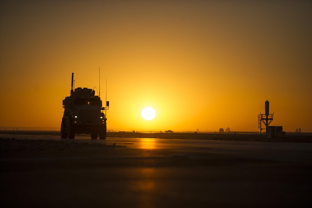 A mine resistant ambush protected vehicle driven by an Air Force airman patrols the flightline as the sun sets on Kandahar Airfield, Afghanistan, Jan. 20, 2016. U.S. Air Force photo by Tech. Sgt. Robert Cloys