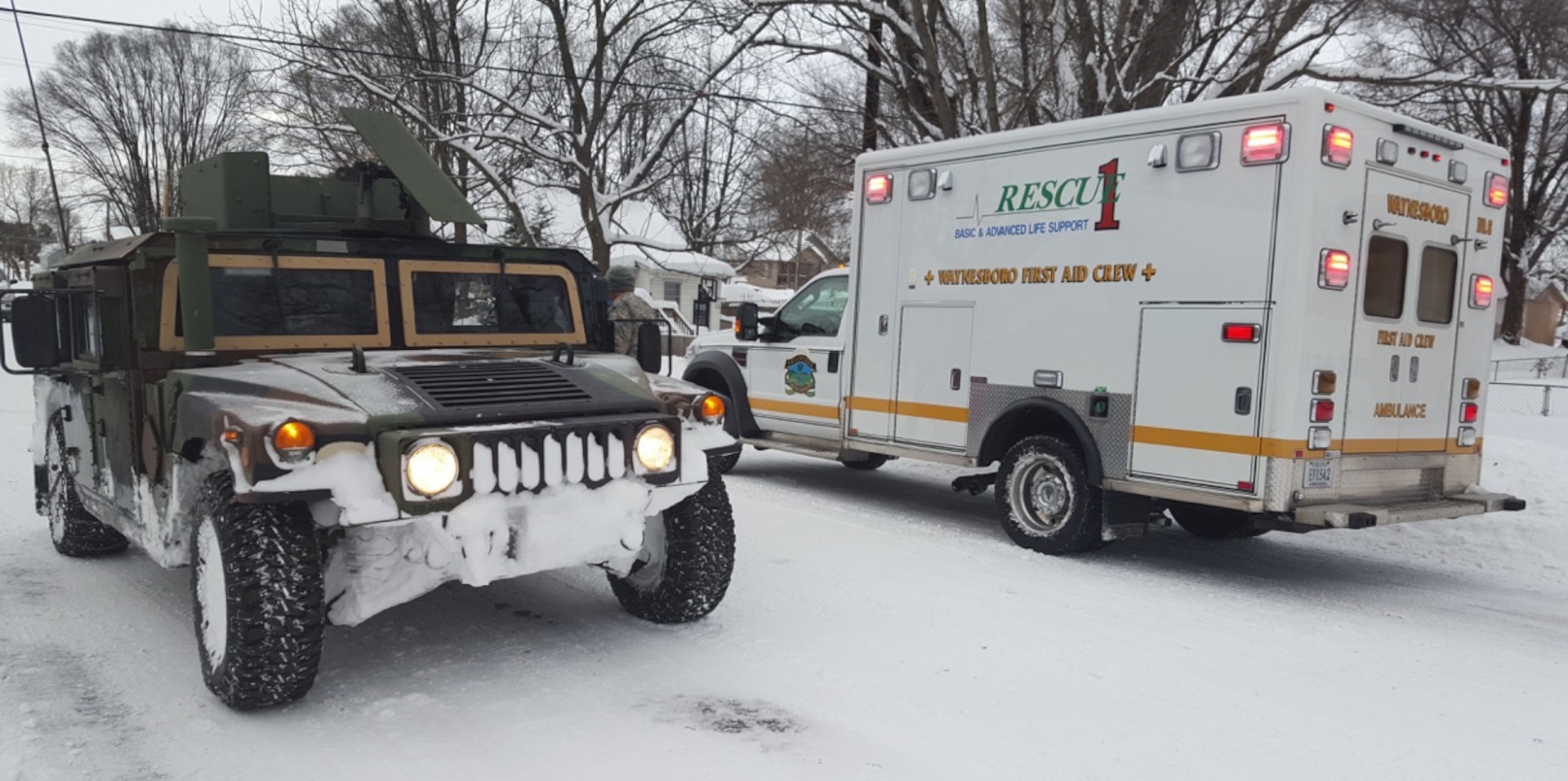 Virginia National Guard Soldiers assigned to the Pulaski-based Company D, 1st Battalion, 116th Infantry, 116th Infantry Brigade Combat Team assist the Waynesboro First Aid Crew with a rescue call Jan. 23, 2016, near Waynesboro, Virginia. The first aid crew was unable to reach the location of the call with their ambulance, so the Soldiers drove them to the residence, cleared them a path in the snow, then transported the patient back to the ambulance for evacuation. 
