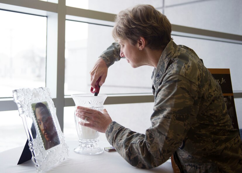 Col. Leah Lauderback, National Air and Space Intelligence Center commander, lights a candle during the Dr. Martin Luther King Jr. Vigil at NASIC, Tuesday, Jan. 19, 2016. The ceremony was held in remembrance of his life accomplishments to include his leadership during the Civil Rights Movement. (U.S. Air Force photo by Senior Airman Justyn Freeman)