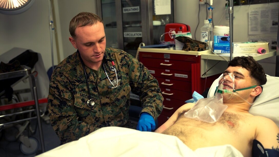 Petty Officer 3rd Class Thomas McCarthy prepares to place an IV for Cpl. Walter Kowalski Jan. 5 at the U.S. Naval Hospital Yokosuka Branch Health Annex on Combined Arms Training Center Camp Fuji, Japan. The annex provides medical evaluation and care to units training on the installation and is typically staffed by less than six permanent personnel. The facility provides an area for service members in training to seek medical evaluation and care. McCarthy is a corpsman with 3rd Battalion 5th Marine Regiment; currently assigned to 3rd Marine Division, III Marine Expeditionary Force under the unit deployment program, and a Visalia, Calif., native. Kowalski is a field radio operator with the battalion and an Amsterdam, N.Y., native.