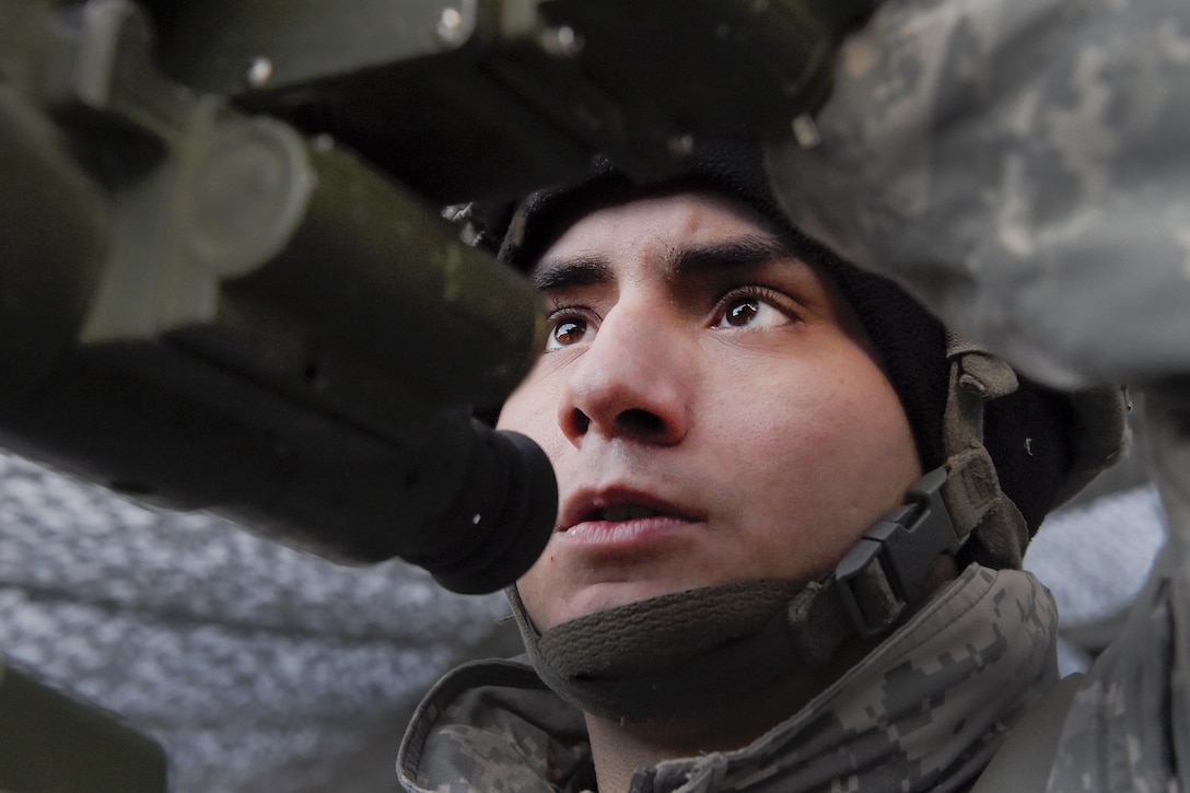 Army Sgt. Michael Jimenez adjusts an M119A2 105mm howitzer gun sight while conducting live-fire training on Joint Base Elmendorf-Richardson, Alaska, Jan. 11, 2016. Jimenez is assigned to the 25th Infantry Division’s 2nd Battalion, 377th Parachute Field Artillery Regiment, 4th Infantry Brigade Combat Team, Airborne, Alaska. U.S. Air Force photo by Alejandro Pena