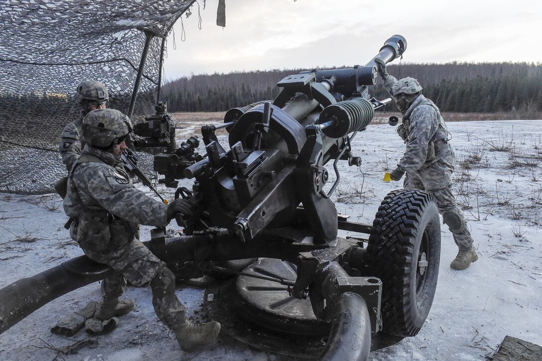 Paratroopers position an M119A2 105mm howitzer while conducting live-fire training on Joint Base Elmendorf-Richardson, Alaska, Jan. 11, 2016. U.S. Air Force photo by Alejandro Pena