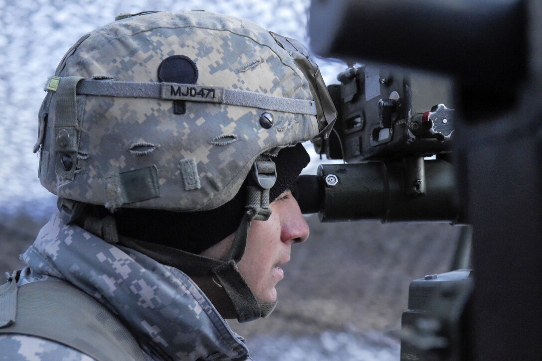 Army Sgt. Michael Jimenez aims an M119A2 105mm howitzer while conducting live-fire training on Joint Base Elmendorf-Richardson, Alaska, Jan. 11, 2016. Jimenez is assigned to the 25th Infantry Division’s 2nd Battalion, 377th Parachute Field Artillery Regiment, 4th Infantry Brigade Combat Team, Airborne, Alaska. U.S. Air Force photo by Alejandro Pena