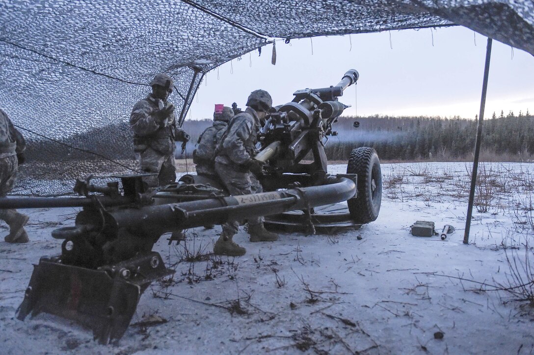 Paratroopers load an M119A2 105mm howitzer while conducting live-fire training on Joint Base Elmendorf-Richardson, Alaska, Jan. 11, 2016. U.S. Air Force photo by Alejandro Pena