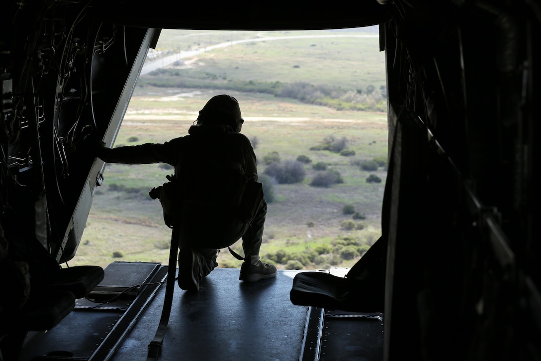Cpl. Joshua Payne, a crew chief with Marine Medium Tiltrotor Squadron (VMM) 161 and a Spring, Texas, native, guides the pilots of an MV-22B Osprey to an unprepared field during casualty-evacuation training aboard Marine Corps Base Camp Pendleton, Calif., Jan. 20. Casualty-evacuation training prepares the Marines to land in a combat zone, pick up injured Marines and transport them to a safe area. (U.S. Marine Corps photo by Lance Cpl. Kimberlyn Adams/Released)