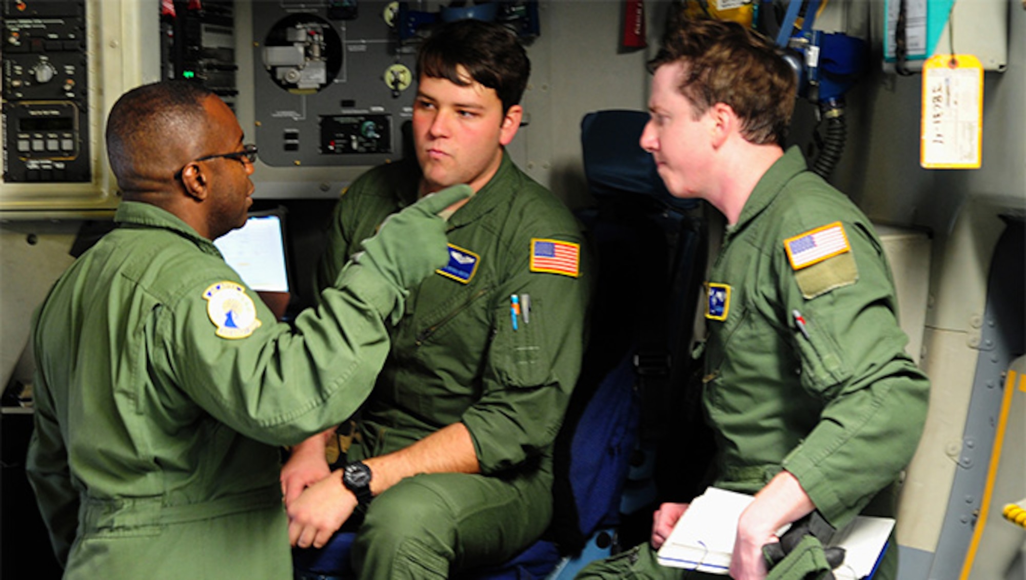 Chief Master Sgt. Reggie Godbolt, the loadmaster superintendent for the 300th Airlift Squadron at Joint Base Charleston, explains expectations to his loadmasters during a training mission to Ramstein Air Base, Germany, Jan. 21, 2016.