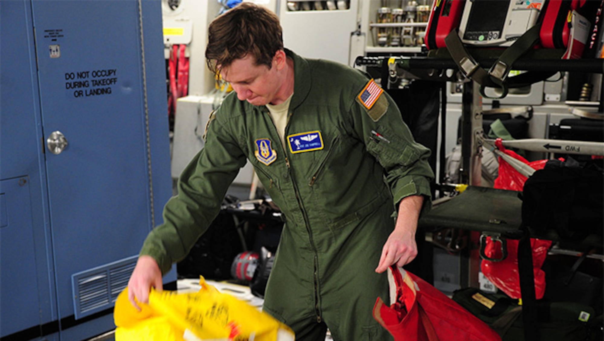 Staff Sgt. Joe Campbell, a loadmaster with the 300th Airlift Squadron at Joint Base Charleston, unpacks a demonstration kit prior to departure for a training mission to Ramstein Air Base, Germany, Jan. 21, 2016.