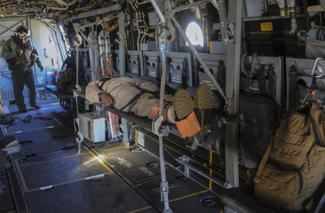 A Marine preparing to deploy with the 31st Marine Expeditionary Unit lies on a litter after being brought onto an MV-22B Osprey with Marine Medium Tiltrotor Squadron (VMM) 161 during casualty-evacuation training aboard Marine Corps Base Camp Pendleton, Calif., Jan. 20. Casualty-evacuation training prepares the Marines to land in a combat zone, pick up injured Marines and transport them to a safe area. (U.S. Marine Corps photo by Lance Cpl. Kimberlyn Adams/Released)